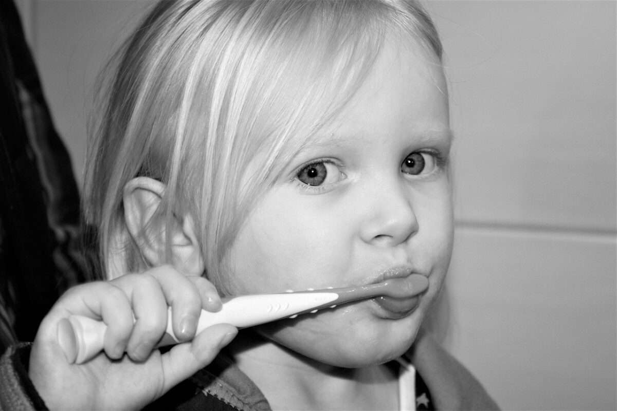child brushing teeth