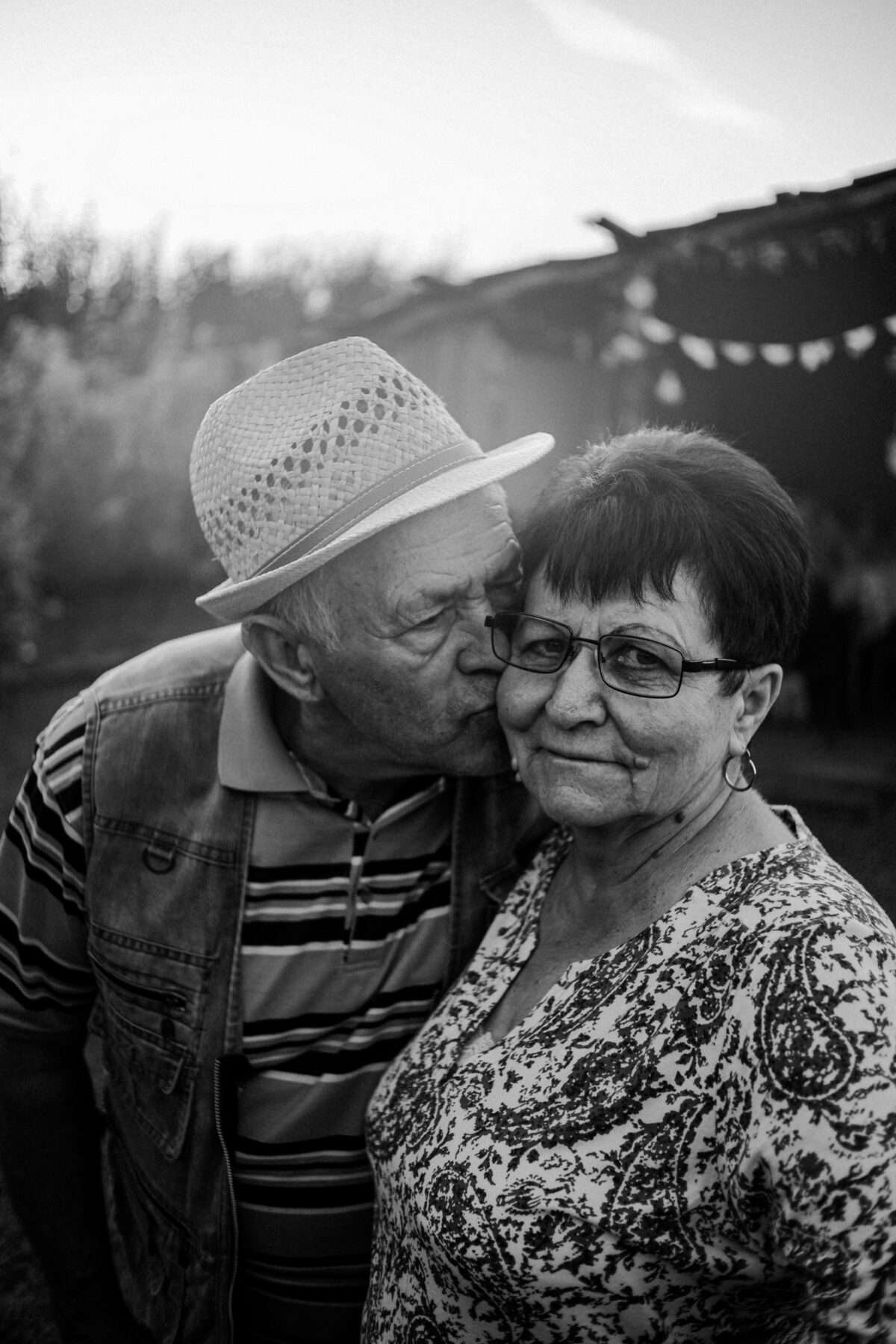 older couple with man kissing woman on cheek