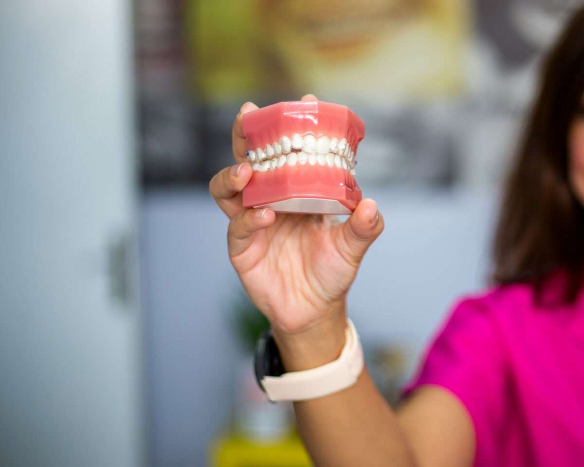 woman holding model of teeth