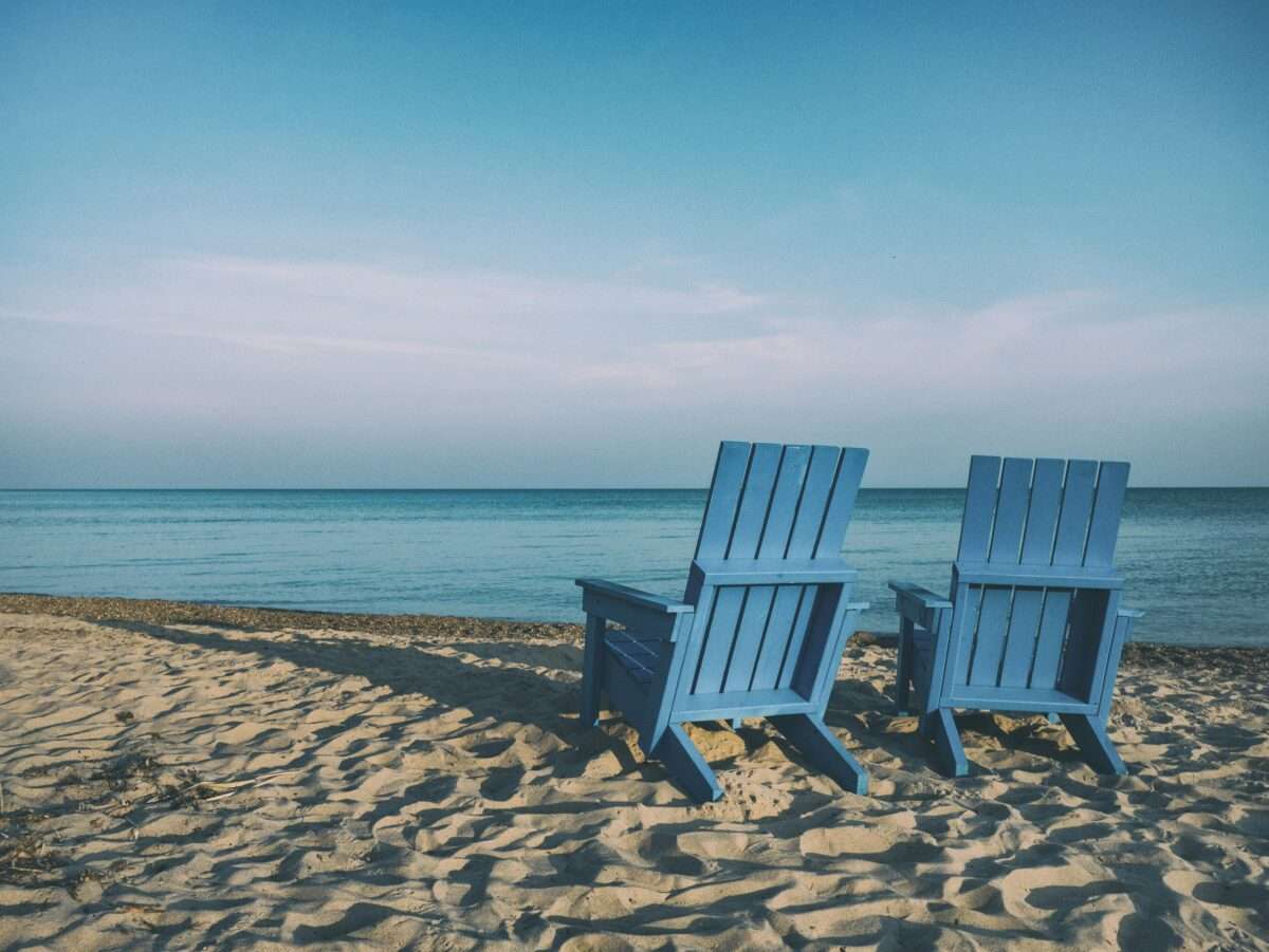 Blue chairs overlooking body of water