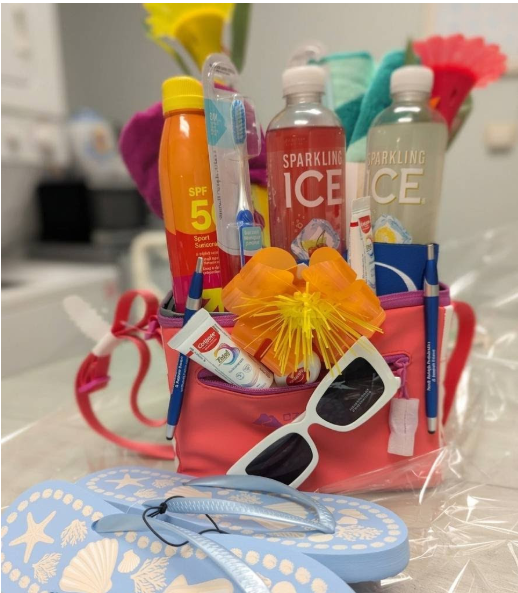 summer giveaway basket including SPF sunscreen, Sparkling Ice drinks, Toothbrushes & dental goodies, Sunglasses and Flip flops